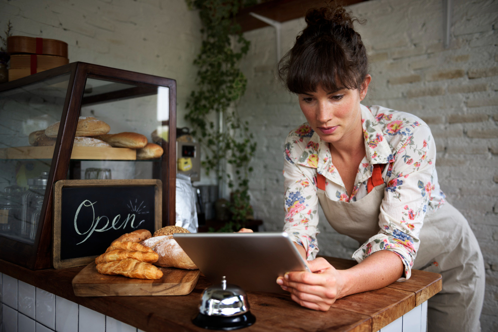 Woman business owner using tablet possibly research how much does seo cost.